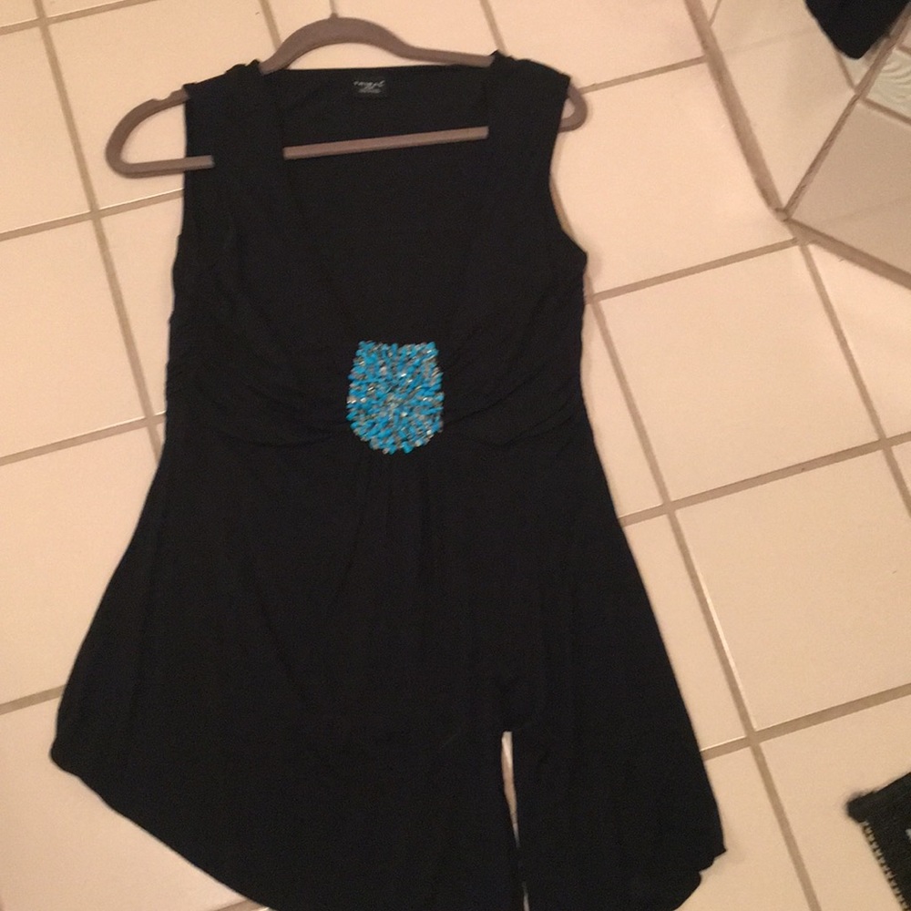 Black knit top with beaded medallion.